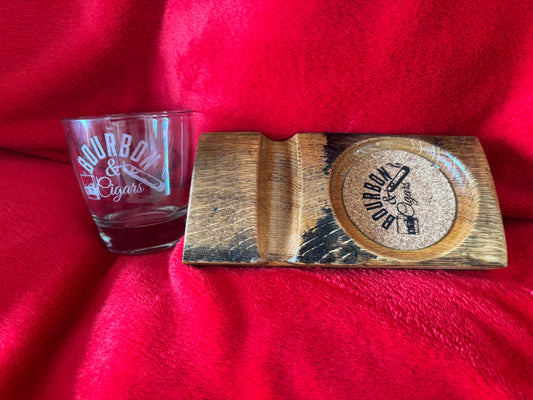 Glass with 'Bourbon & Cigars' text and wooden coaster set